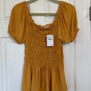 Pro Blue dress top color is mustard